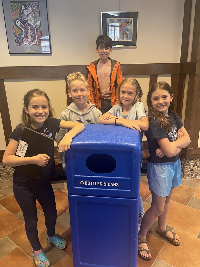 students standing by the recycling bin